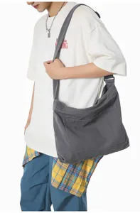 Detailed view of dark gray canvas shoulder bag, casual everyday style with roomy interior.