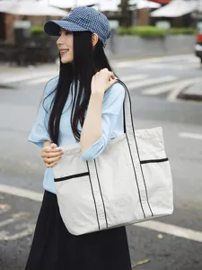 Large capacity canvas tote bag for women, casual commuter shoulder bag with stylish black trim.