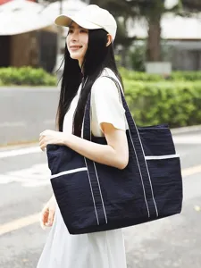 Large capacity navy blue tote bag for women, casual commuter shoulder bag with white trim.