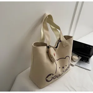 Canvas tote bag detail view, casual large capacity shoulder bag for daily commuting and travel.