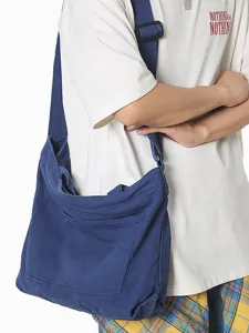 Casual blue canvas shoulder bag for women and men, large capacity cross-body commuting bag.