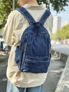 Casual denim backpack for women, stylish student school bag and solid travel rucksack.