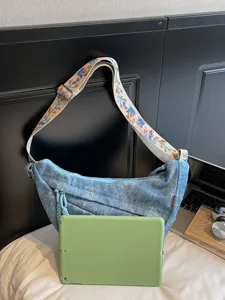 Casual denim crossbody bag with colorful embroidered strap, stylish large capacity shoulder bag.