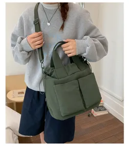 Casual nylon tote bag in dark green, featuring multi-pockets and comfortable shoulder strap.