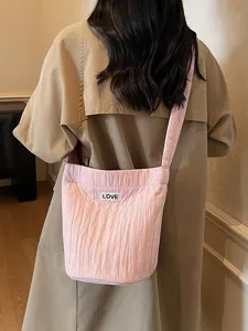 Chic pink pleated shoulder bag for women, casual crossbody bag with spacious daily capacity.
