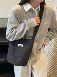 Casual black quilted shoulder bag with white LOVE label, trendy large capacity design.