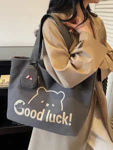 Stylish large capacity canvas tote bag with cute bear print and shoulder strap for women.