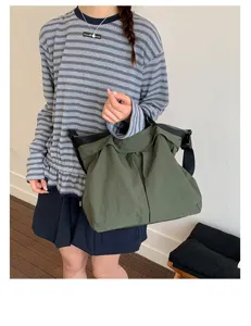 Dark green nylon shoulder bag detail, large capacity casual crossbody design for daily use.