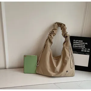 Detailed view of casual slouchy shoulder bag with ruched strap, lightweight and spacious.