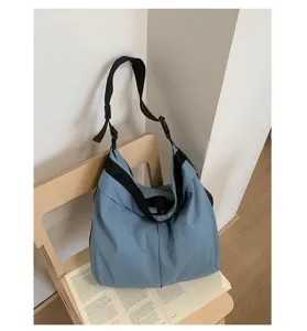 Casual blue shoulder bag with black strap, stylish large capacity daily commuter handbag.