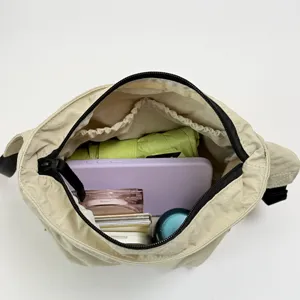 Interior detail view of a beige casual shoulder bag showing large capacity storage space.