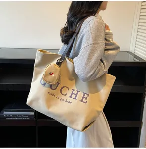 Canvas tote bag detail showcasing sturdy handles and graphic print for stylish daily wear.