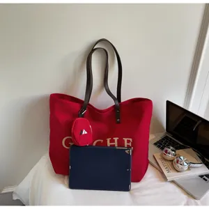 Red canvas tote bag with brown straps, large capacity casual shoulder bag for daily commute.