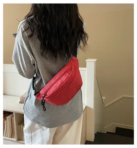 Red grid chest bag crossbody lifestyle detail view, lightweight commuter sports waist bag.