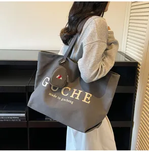 Casual grey canvas tote bag with small pouch, stylish shoulder bag for daily commute and travel.