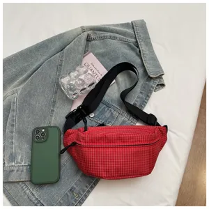 Red plaid chest bag featuring durable nylon fabric, adjustable strap, and secure zip pocket.