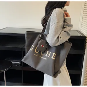 Casual canvas tote bag for women, large capacity shoulder bag, stylish commuter travel handbag.
