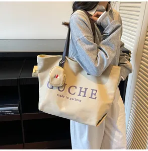 Canvas tote bag with shoulder strap and mini pouch detail, casual daily shopping handbag.