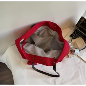 Red canvas tote bag, large capacity casual shoulder bag with dark brown straps for daily commute.