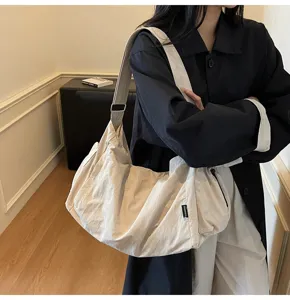 Stylish slouchy shoulder bag, large capacity canvas crossbody bag for daily commute and travel.