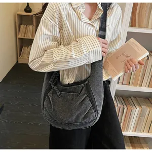 Stylish casual denim shoulder bag detail showing washed fabric, zipper pockets and spacious daily use.