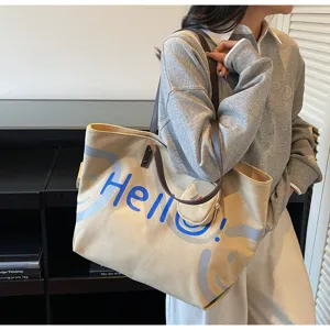 Canvas tote bag detail view, large capacity shoulder bag with Hello print and small pouch.