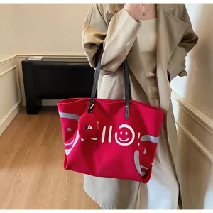 Red canvas tote bag detail, featuring a cute attached coin purse and stylish graphic print.