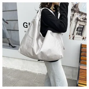 Detail view of a trendy silver metallic hobo shoulder bag, large capacity, casual commuter style.