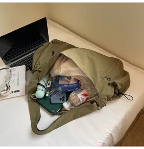 Olive green large capacity shoulder bag versatile casual nylon crossbody tote for travel.