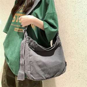 Lässige gewaschene Canvas Schultertasche mit Rohteilen ideal für Studenten im Alltag.