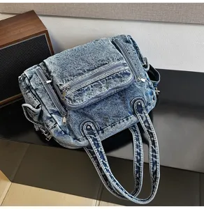 Retro soft denim crossbody bag detail, large capacity casual commuter shoulder tote bag.