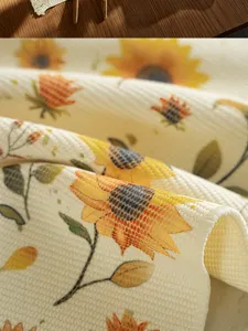 Close-up detail of vintage sunflower cotton fabric placemat, retro floral kitchen table mat.