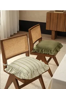 Detailed view of striped cotton chair cushion with cute ruffles, French vintage home decor.