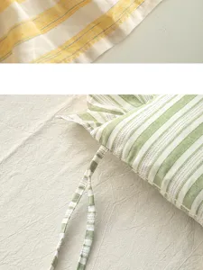 Close-up detail of cotton striped chair cushion with ties and vintage style fabric texture.