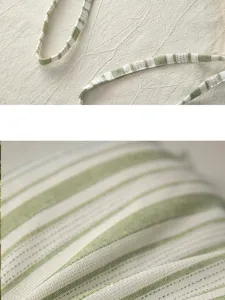 Close-up detail of the green striped cotton chair cushion fabric and strap design.