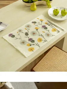 French retro style woven placemat detail showing delicate floral pattern and fringe edge.