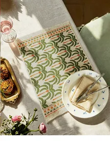 Close-up detail of vintage cotton placemat with palm tree print and fringe trim design.
