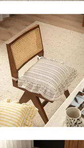 Close-up detail of a French vintage striped cotton chair cushion with ruffle edge and ties.
