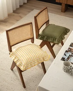 Detail of cotton striped chair cushion with ruffled edge, vintage French style seat pad