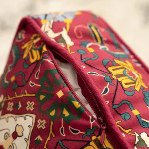 Close-up detail of vintage ethnic printed cushion cover with zipper, showcasing fabric texture.