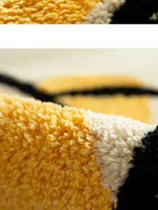 Microfiber tufted rug detail macro shot, soft yellow white black texture close-up view.