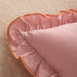 Pure cotton pink pillowcase featuring a vibrant orange-trimmed ruffled edge for home decor.