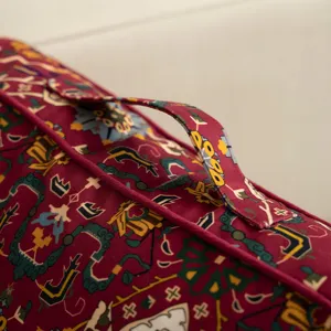 Close-up detail of vintage ethnic style floor cushion with handle, retro geometric pattern.
