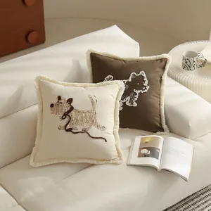 Detailed close-up view of cute embroidered puppy cushion covers featuring stylish fringe trim.