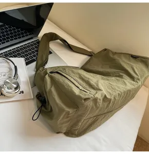 Olive green nylon shoulder bag detail, casual large capacity crossbody design for daily use.
