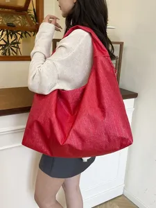 Stylish red shiny shoulder bag for women, large capacity hobo tote for commuting and travel.