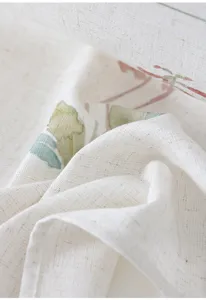 Detailed close-up shot of imitation linen fabric curtain featuring elegant botanical floral print.