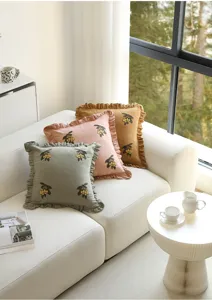 Detailed view of embroidered fruit cushion cover with ruffled edges for modern living room sofa decor.