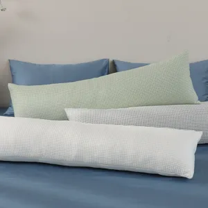 Detailed view of long body pillow for side sleeping, cooling fabric, washable cover in scene.
