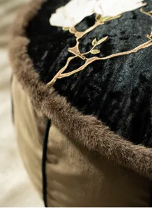 Close-up of Chinese style magnolia embroidered floor cushion with soft faux fur border detail.